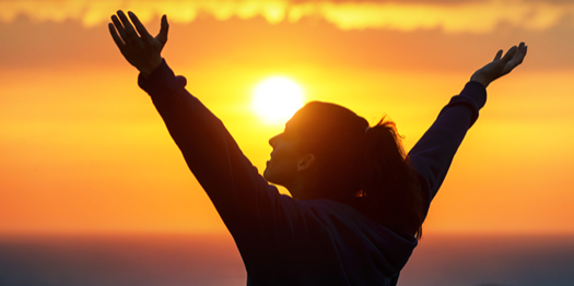 happy-successful-woman-against-sunset.png