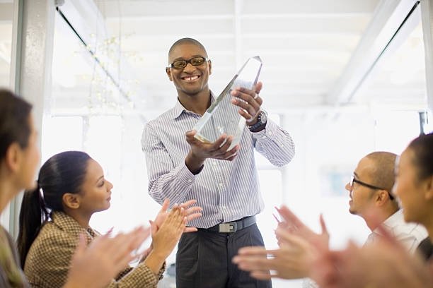 businessman-holding-award-in-meeting-picture-id134574767.jpg