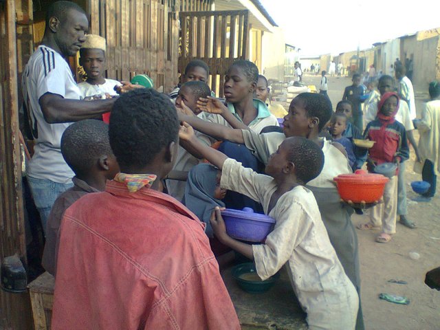 Almajiri_mendicants_stretching_hands_to_collect_sweet_as_Sadaka._Many_people_in_Hausa_land_give_'Sadaka'_to_almajirai_on_daily_basis_seeking_Divine_reward_and_protection.jpg