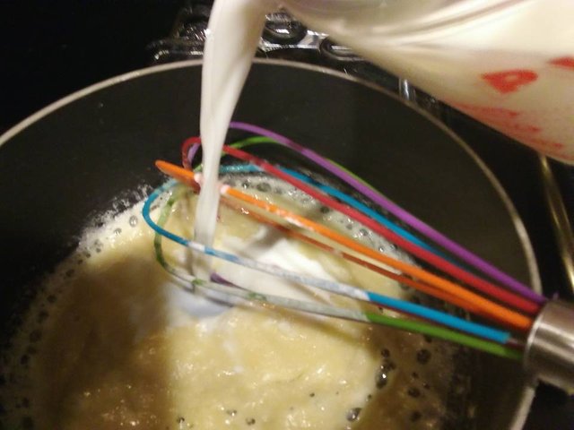 mac and cheese 7 whisk in cup of milk.jpg