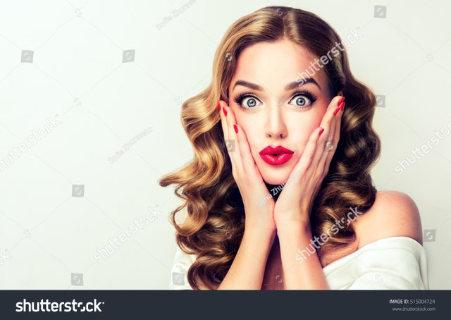 stock-photo-woman-surprise-holds-cheeks-by-hand-beautiful-girl-with-curly-hair-pointing-to-looking-right-515004724.jpg