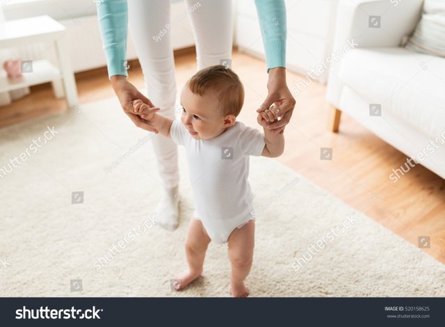 stock-photo-family-child-childhood-and-parenthood-concept-happy-little-baby-learning-to-walk-with-mother-520158625.jpg