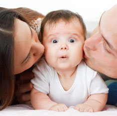 parents-kissing-baby.jpg