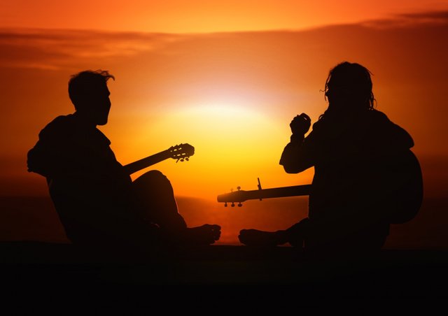 men-playing-guitars-at-sunset.jpg