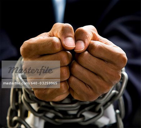 640-03259965em-businessmans-hands-bound-in-chains-stock-photo.jpg