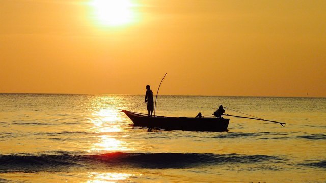 fishing-at-sunset-on-black-boat-freedomain.jpg