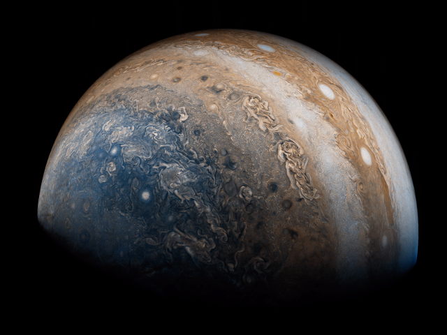 Juno-has-also-captured-more-distant-images-of-Jupiter-This-striking-view-of-the-planets-south-pole-was-taken-May-19-then-processed-by-two-citizen-scientists-to-bring-out-the-photos-contrast-and-color-.png