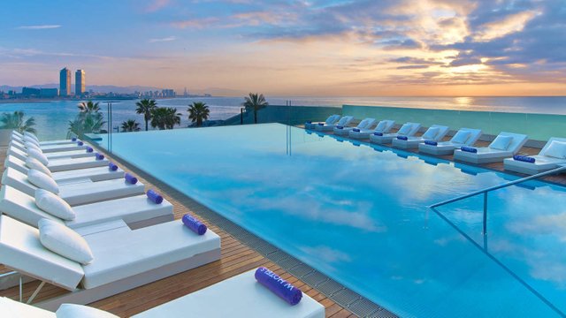 swimming-pool-with-view-of-the-beach-at-sunset-w-barcelona.jpg