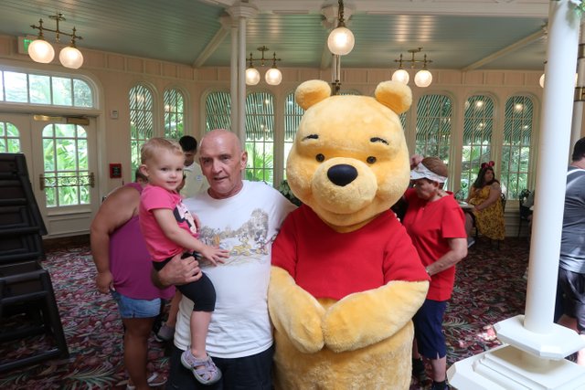 Papa with winnie the pooh crystal palace dinning room Magic Kingdom theme park at Walt Disney World Resort September 2017.JPG