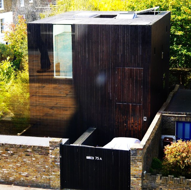 11136097015 - a cubic house with wood cladding amongst the.jpg