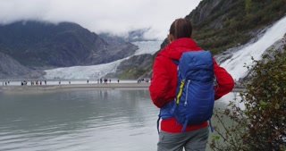 videoblocks-hiker-woman-wearing-hiking-backpack-in-alaska-nature-looking-at-glacier-landscape-woman-on-travel-adventure-enjoying-view-of-mendenhall-glacier-and-nugget-falls-waterfall_b1_5b4ckb_thumbnail-small15.jpg