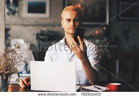 stock-photo-smart-guy-working-with-laptop-in-coffee-shop-702912403.jpg