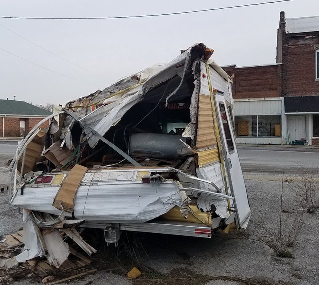 A smashed up camper from the back showing the most damage