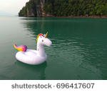 stock-photo-unicorn-swim-tube-floating-on-the-sea-696417607.jpg