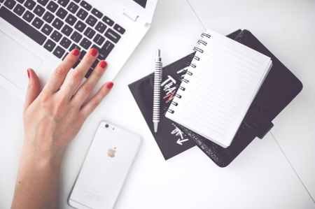 woman-hand-smartphone-desk pexels.jpg