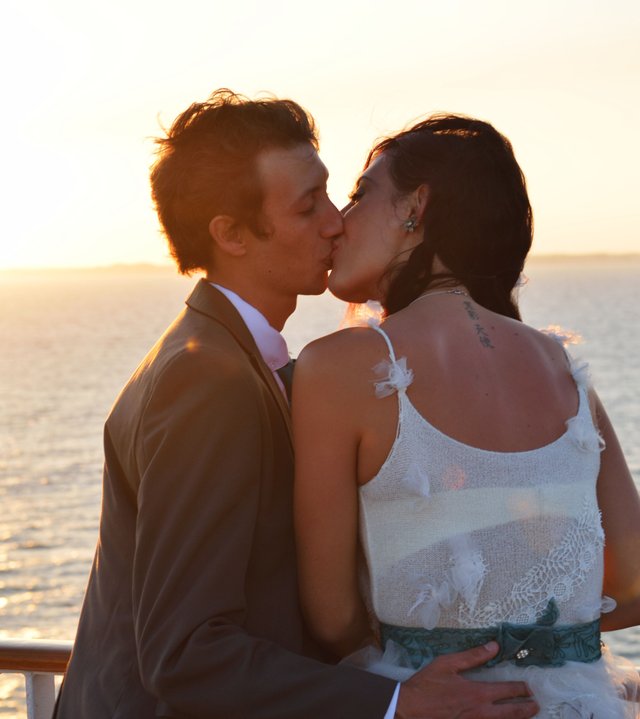  goldenhourphotography photography wedding sunset kissing couple married happy on a boat.jpg