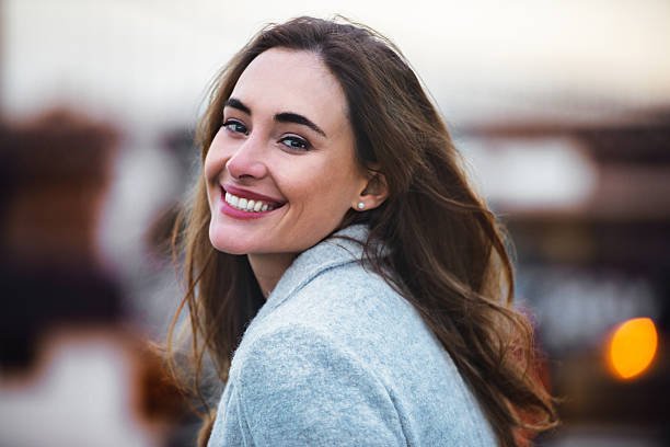 beautiful caucasian woman with charming smile walking outdoors stock photo.jpg