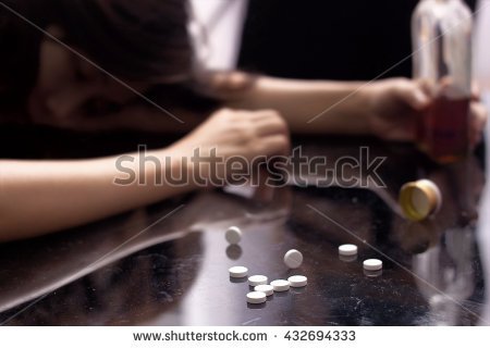stock-photo-several-pill-spilled-on-table-near-bottle-of-alcohol-432694333.jpg