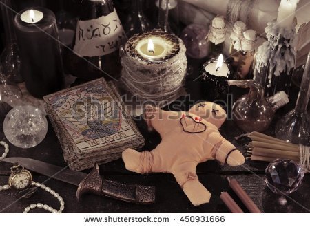 stock-photo-halloween-close-up-of-voodoo-doll-tarot-cards-candles-vintage-bottles-and-magic-objects-450931666.jpg