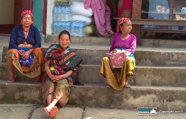 Nepali ladies sittin on a kerb.jpg