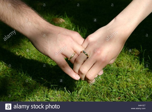 true-love-and-togetherness-man-and-woman-holding-hands-with-golden-A4H1E7.jpg