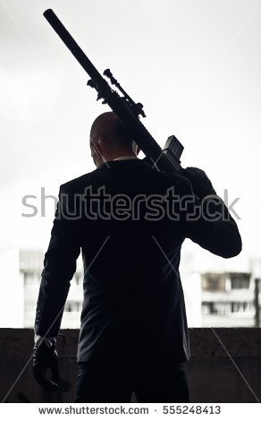 stock-photo-silhouette-of-killer-or-hitman-with-weapons-at-day-shot-holding-rifle-sniper-rifle-blurred-555248413.jpg