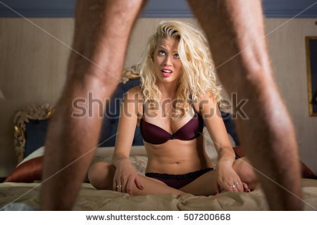 Woman in disbelief looking what's between man's legs Stock Photo