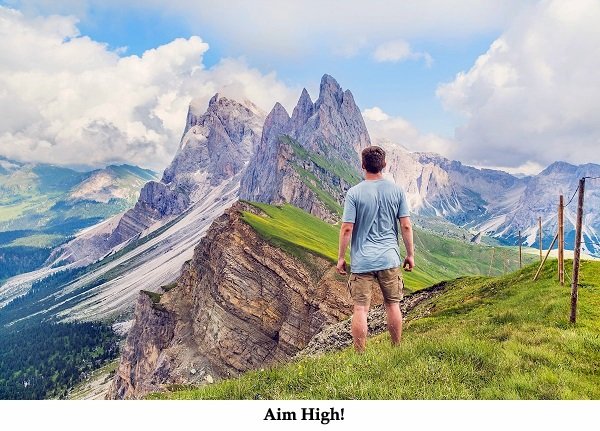 joshua-earle-117661 man in shorts looking at jagged peaks text space below aim high.jpg