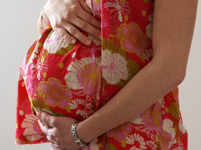 pregnant woman holding bump.jpg