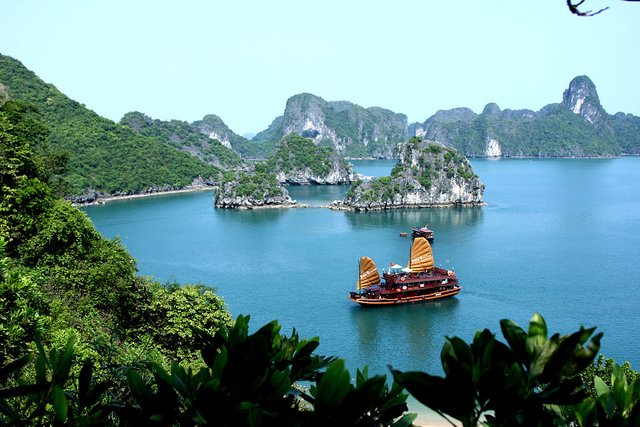 An Asia Cruise junk, sits in the idyllic scenery of Halong Bay.jpg