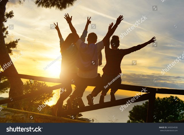 stock-photo-rear-view-of-three-couple-best-friends-travelers-put-hands-up-at-sunset-young-relaxing-hipster-345054938.jpg