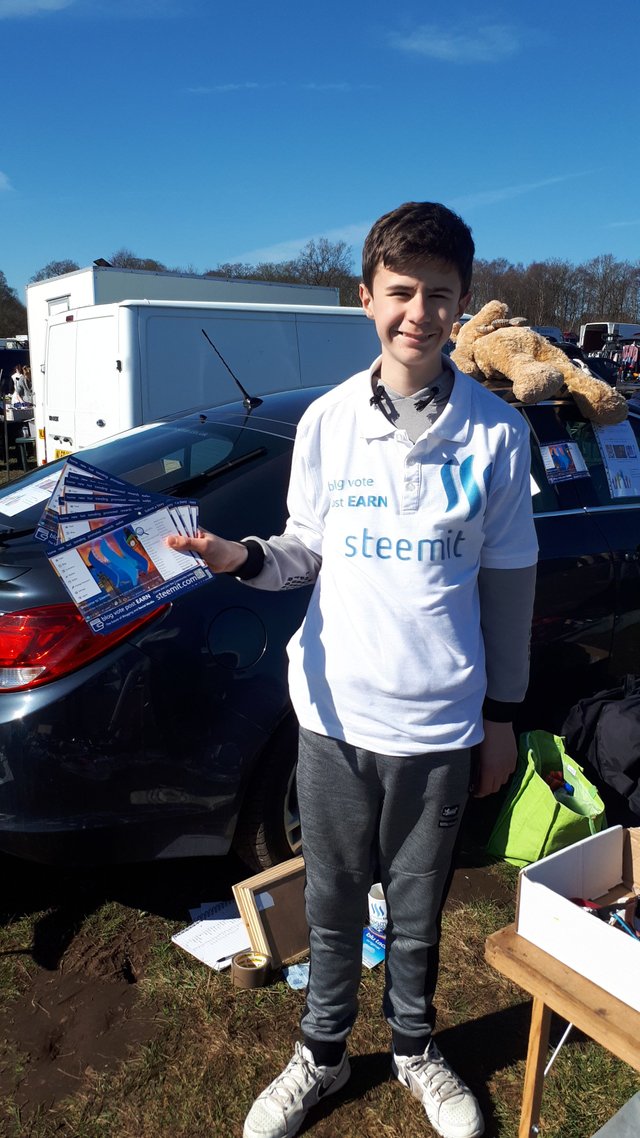 Close up of me holding some steemit leaflets .jpg