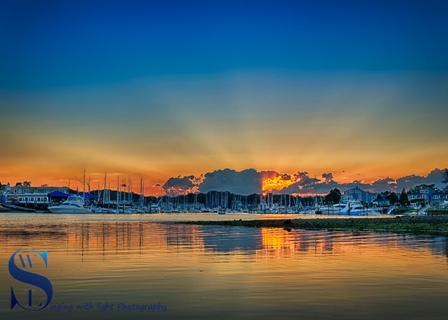 Sun setting over the harbor 25 June.jpg