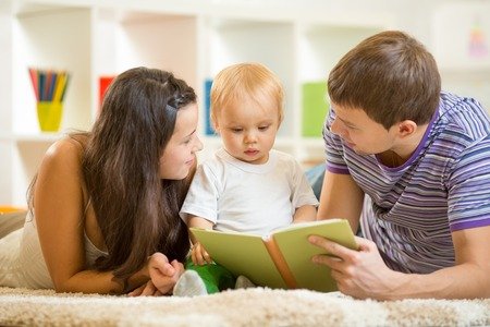 33530285-young-parents-mom-and-dad-reading-children-book-to-baby-son.jpg