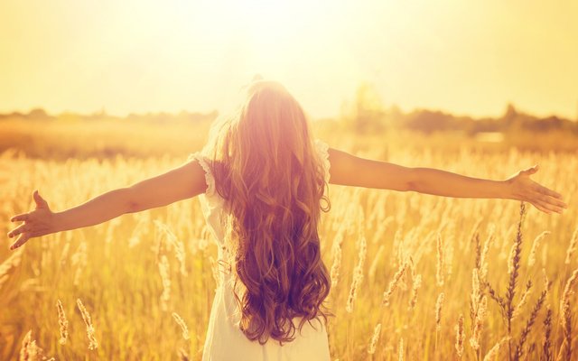 a-beautiful-girl-with-very-curl-long-hair-standing-on-the-wheat-field-in-sunshine.jpeg