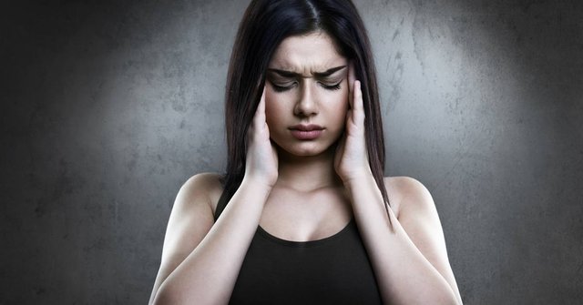 stressed-young-woman-holding-hands-to-temples-large.jpg