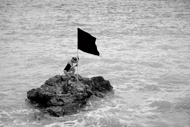 flag-on-rock-woman-conquer-freedomain.jpg