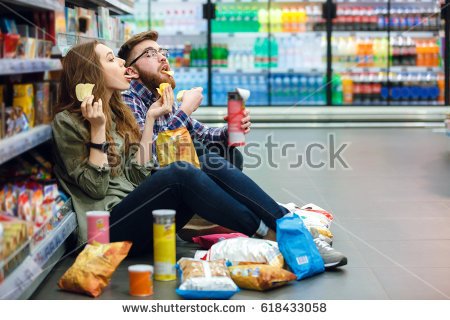 stock-photo-portrait-of-a-young-funny-hungry-couple-sitting-on-the-supermarket-floor-and-eating-junk-food-618433058.jpg