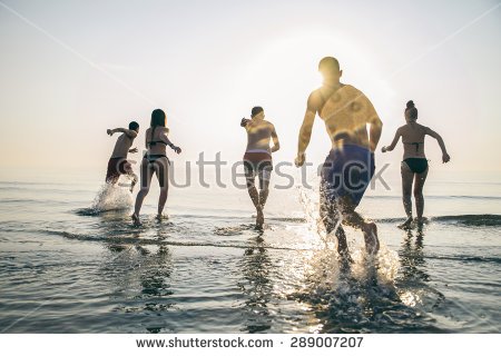 stock-photo-group-of-happy-friends-running-in-to-water-at-sunset-silhouettes-of-active-people-having-fun-on-289007207.jpg