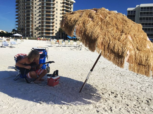 Guy playing guitar on the beach.jpg