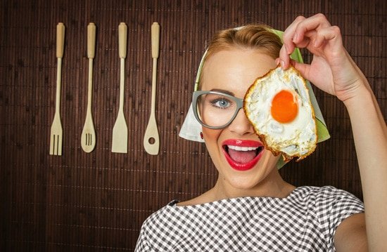 woman-smiling-holding-a-fried-egg.jpg