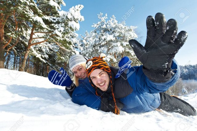 24300262-happy-young-smiling-adult-people-in-warm-clothing-sledding-on--Stock-Photo.jpg