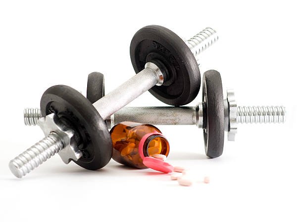 dumbbells-and-a-bottle-of-pills-on-white-background-picture-id157436504.jpeg
