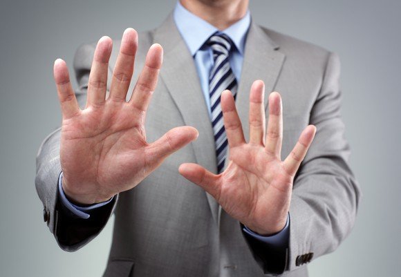 businessman-holding-hands-up-stop-avoid-getty_large.jpg