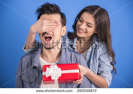 stock-photo-girl-is-giving-a-gift-to-her-boyfriend-isolated-on-blue-background-260559872.jpg