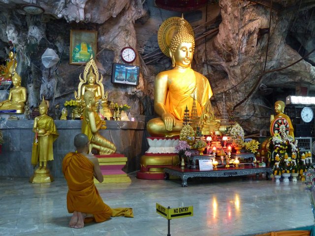 Monk praying inside the Tiger Cave temple in Krabi