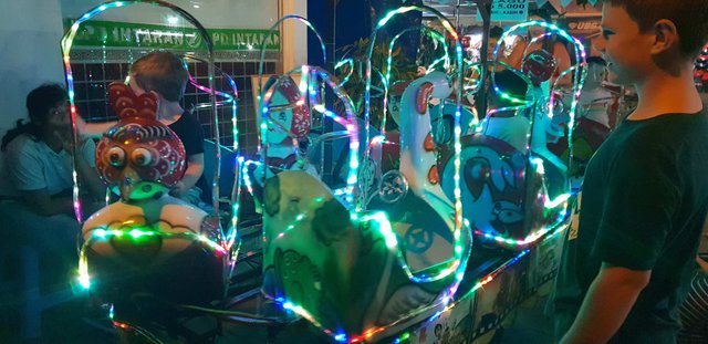 Kids enjoying a play ride at Pasar Sindhu night market