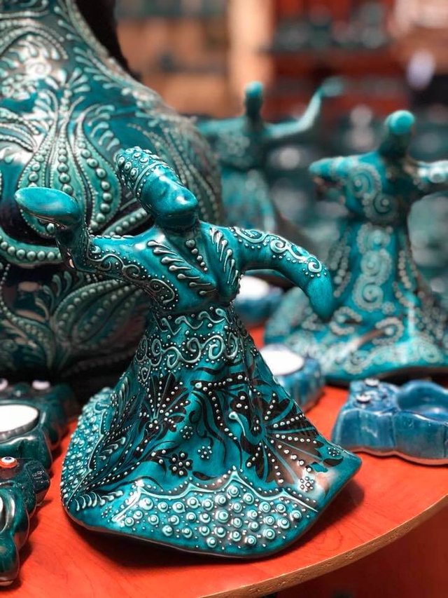Turquoise blue ceramic artwork of the "Wherling Dervishes" at the Ceramik Kapadokya pottery workshop