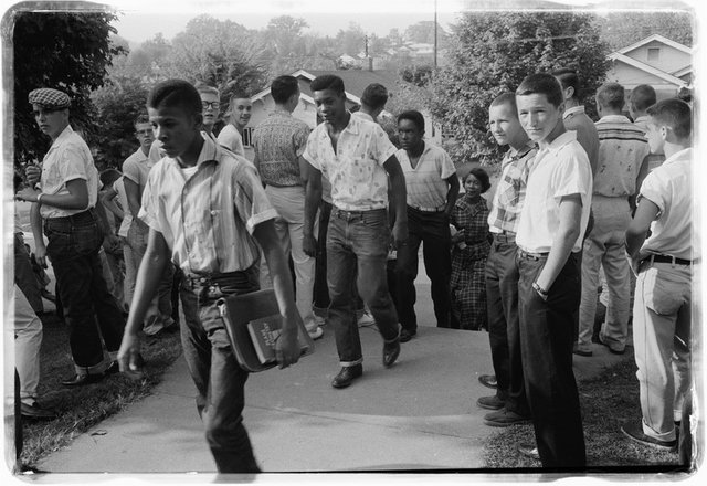 A line of African American boys walking through a crowd of white boys during a period of violence related to school integration in Clinton, Tennessee, 1956. Photo by Thomas J. O'Halloran. Public domain.