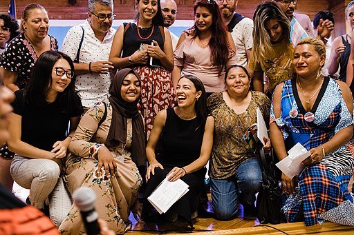 US Representative Alexandria Ocasio-Cortez (D-NY) laughs at some of the people she's fooled into believing she's "working class." Public domain.